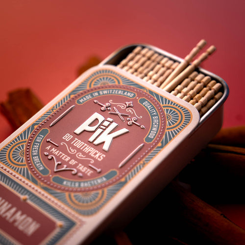 Close-up of Pik cinnamon-flavored toothpicks in premium metal tin – 100% vegan, made in Switzerland, bold natural flavor.